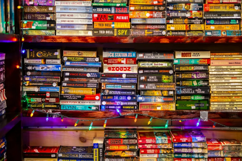 a shelf of video dvds in an area with lights