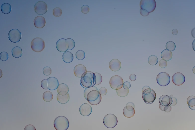 soap bubbles are flying up in the sky