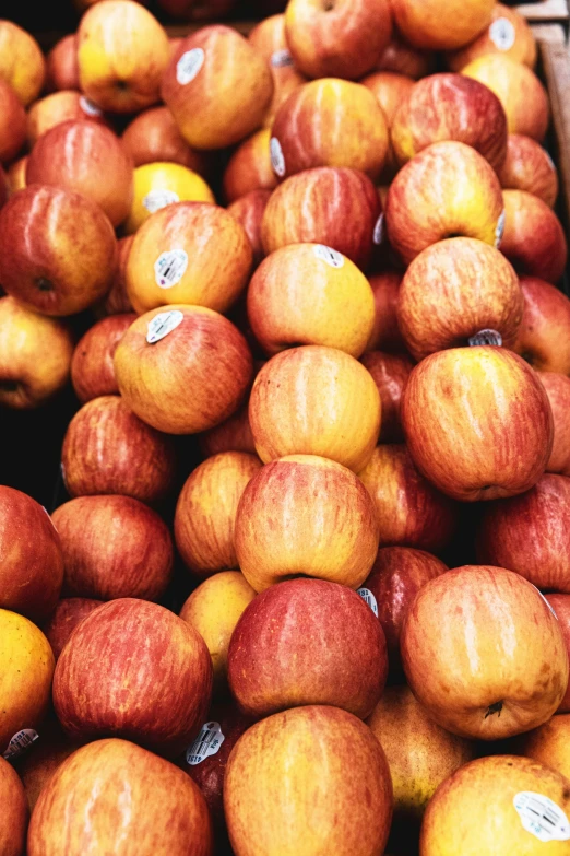 red and yellow apples for sale in a market