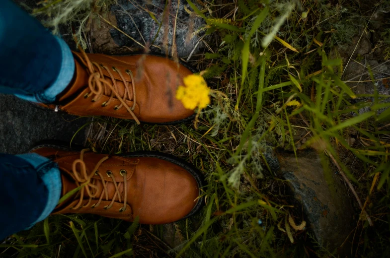 a person with some shoes and a flower