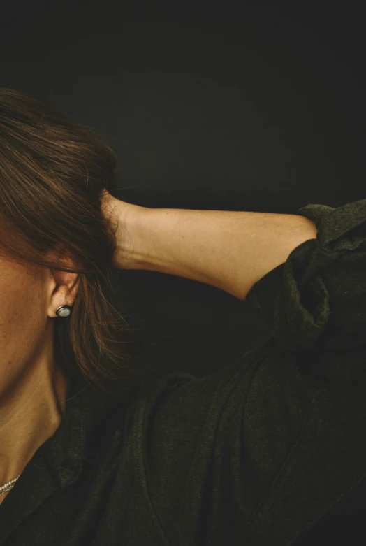 a woman is touching her ears to hear the sounds