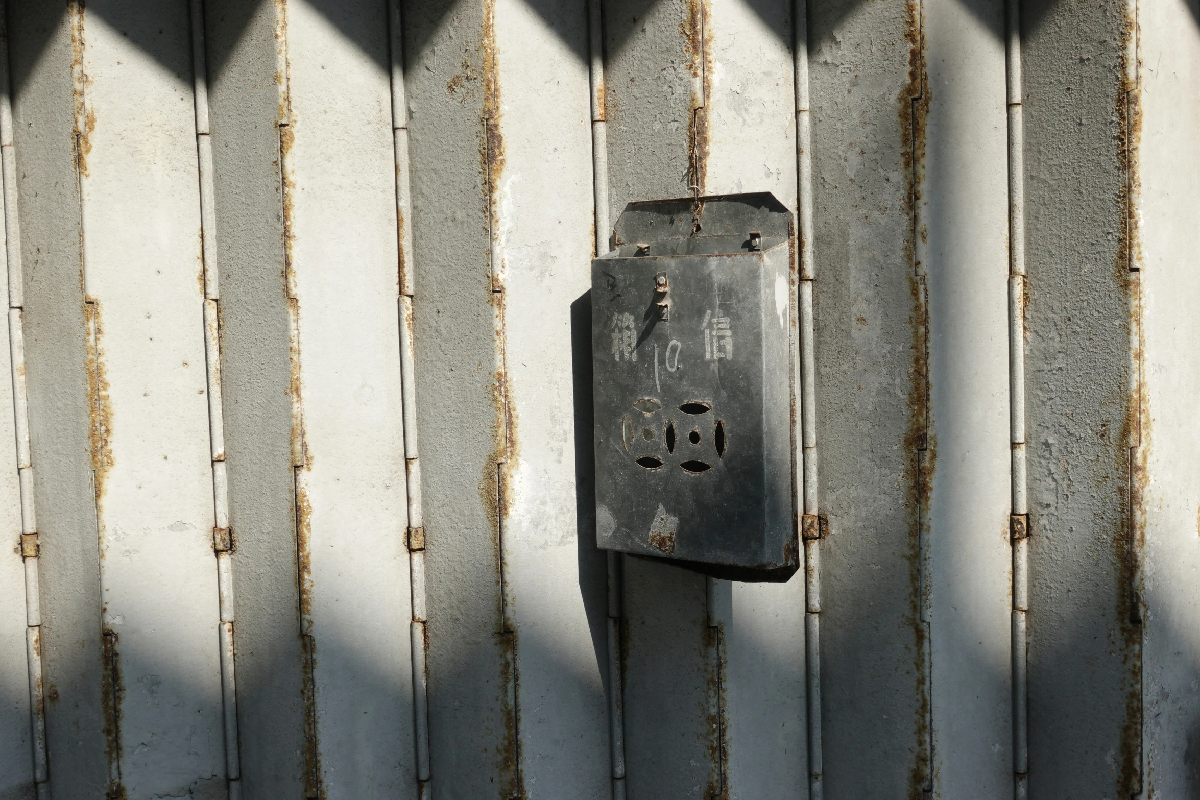 a close up of a metal block with rust and scratches