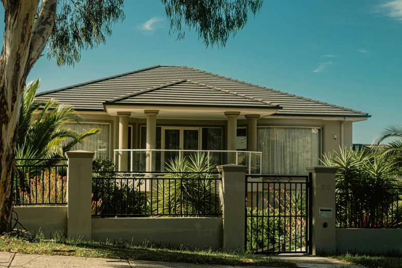 a house with a nice porch next to the fence