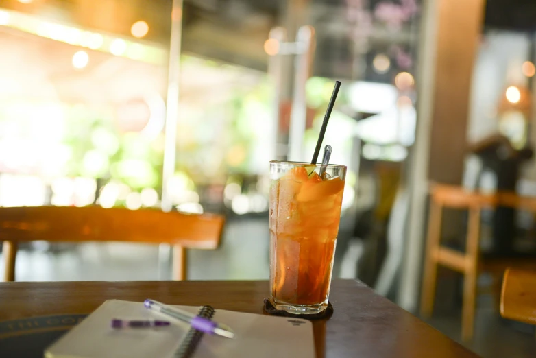 a cocktail is on a table in an empty restaurant