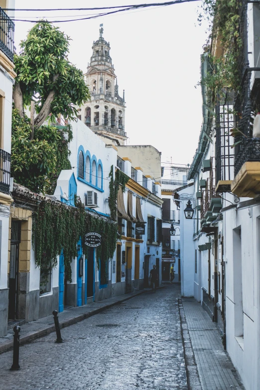 a cobblestone street with blue and white buildings