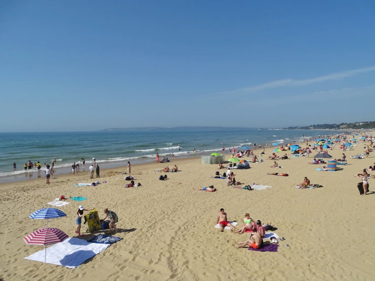 people are on the beach during the day