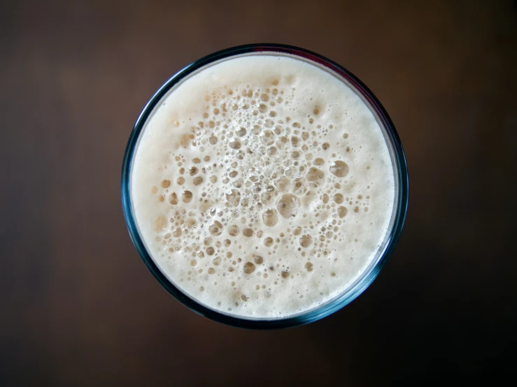 a glass of beer sits on a table