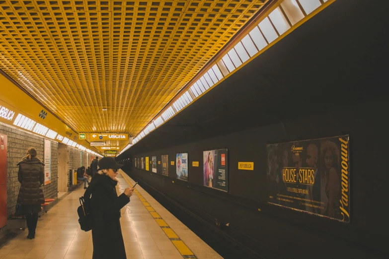 a person waiting for a train in an underground station