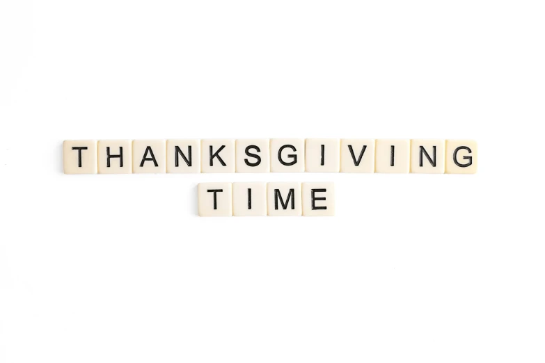 three wooden letters spelling out the words thanksgiving time