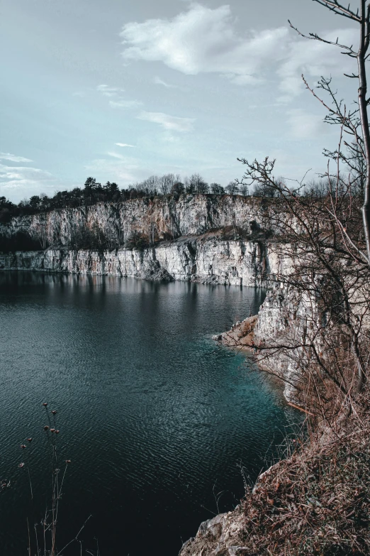 a lake on top of a hill with water below