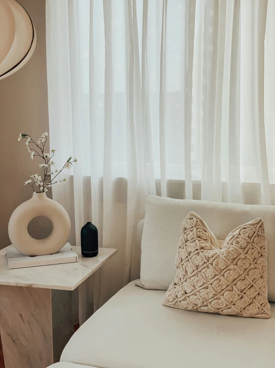 a close up of a pillow on a couch near a window