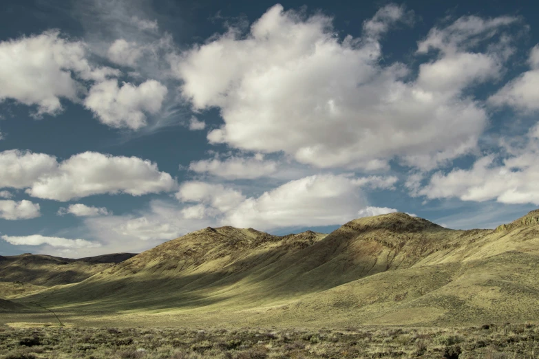 a view of mountains under a cloudy sky