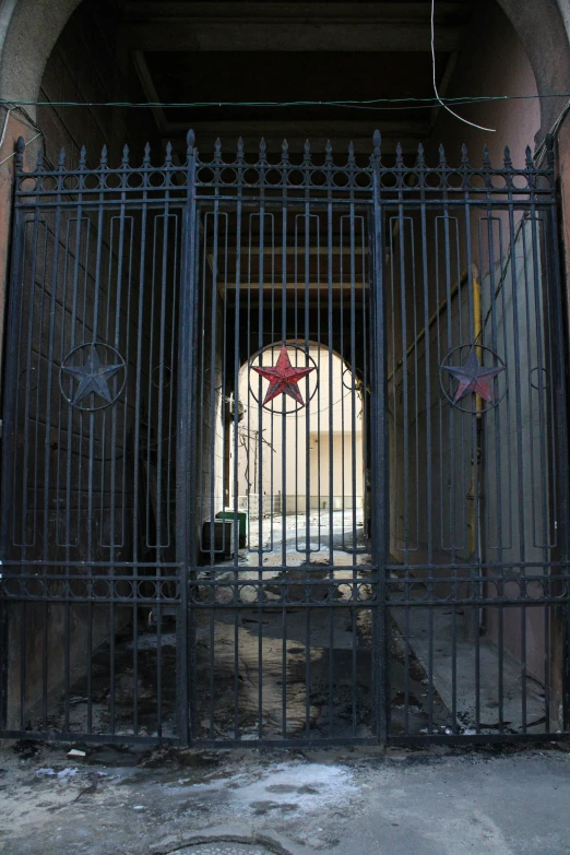 the doorway has a rusty iron fence near it