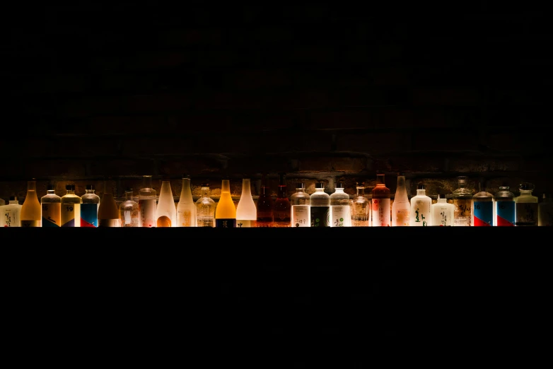 many bottles in an array and illuminated by a long exposure