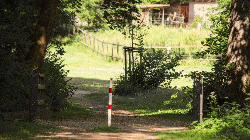 the gate to the barn has two signs