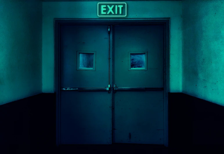 a green door with the exit sign above it