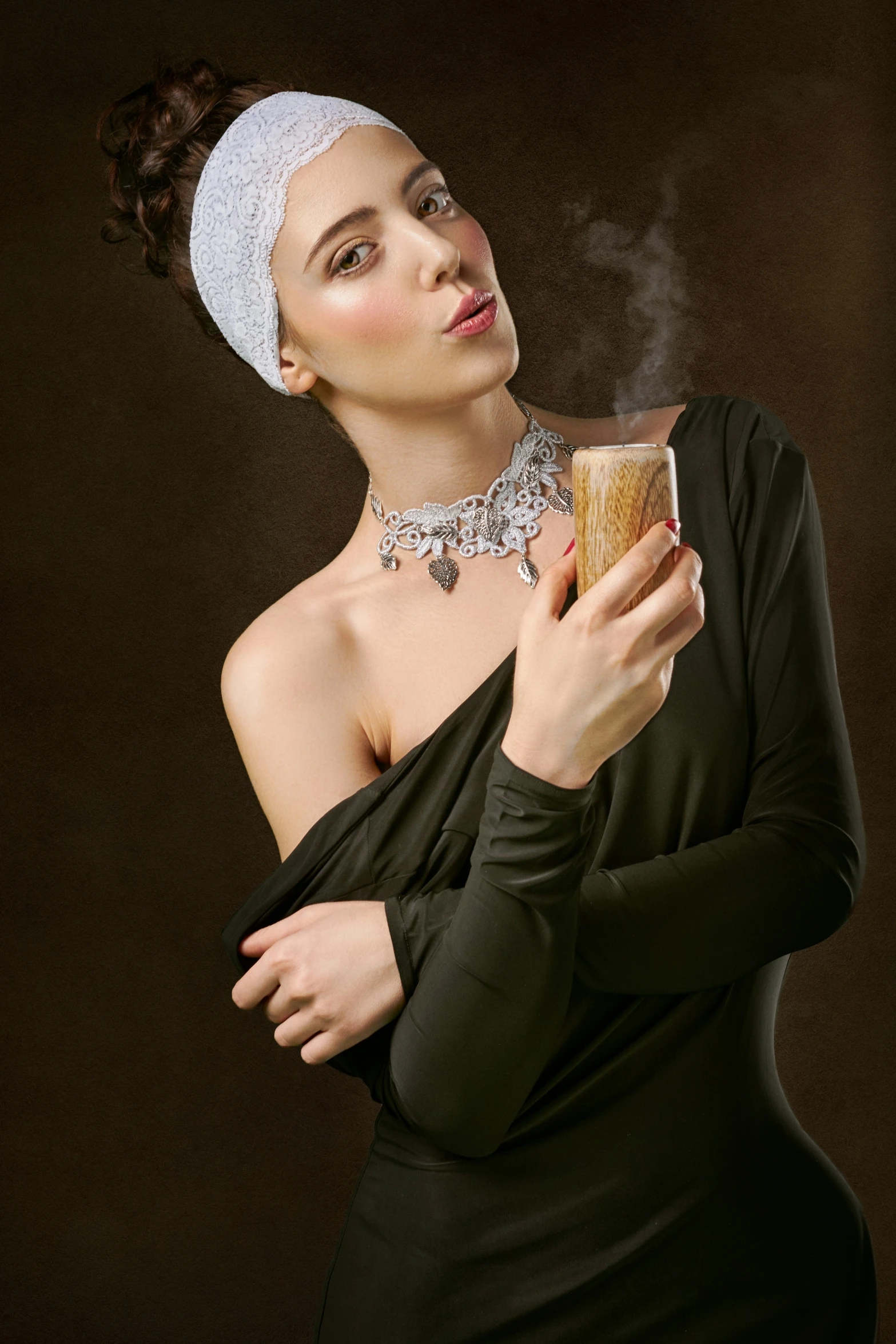 woman wearing black dress smoking a cigarette and holding a brown cup