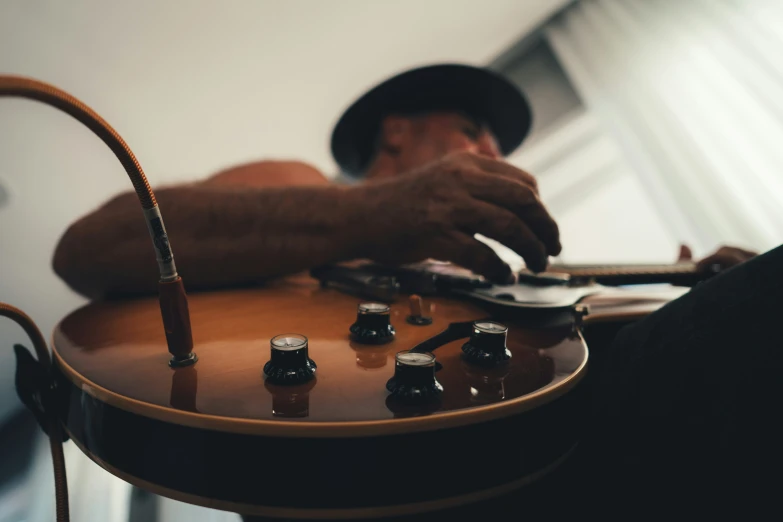 the man is holding an electric guitar with several bottles on it