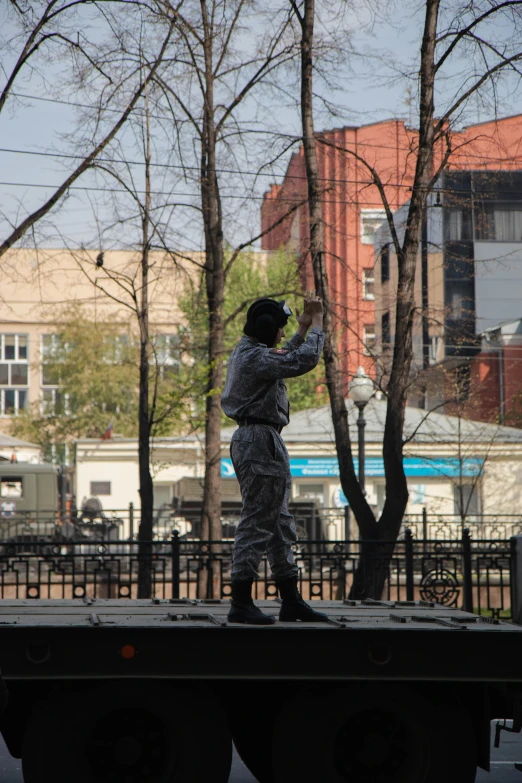 a man on a truck taking a po with his cell phone