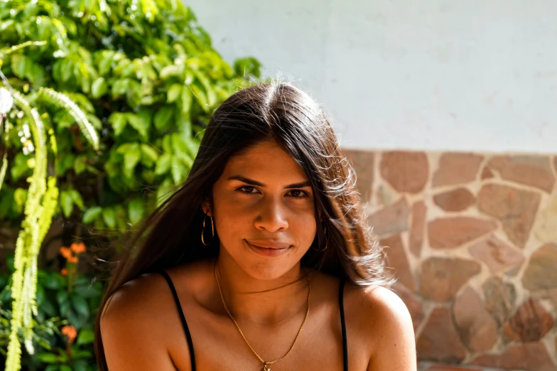 a close up of a person wearing gold necklaces