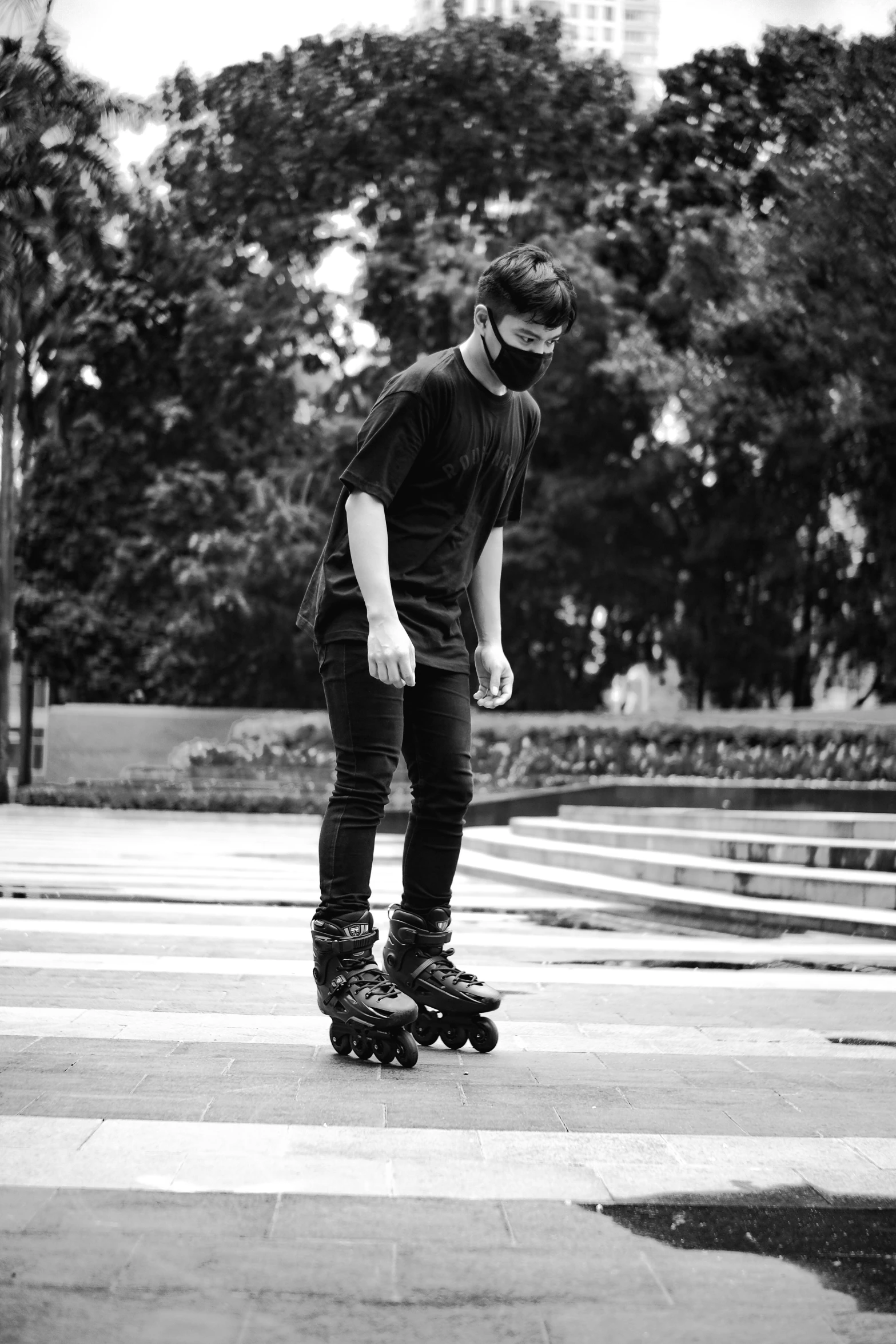 a boy on a skateboard riding through the crosswalk