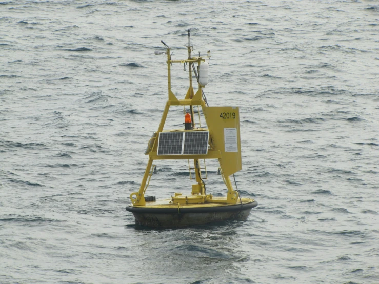 solar powered boat in body of water with sky background