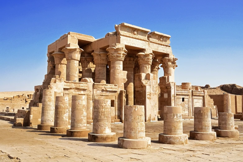 many stone pillars in the middle of an empty area