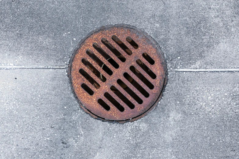 a manhole cover in a concrete floor