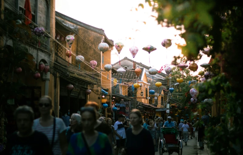 many people in a city on a sunny day