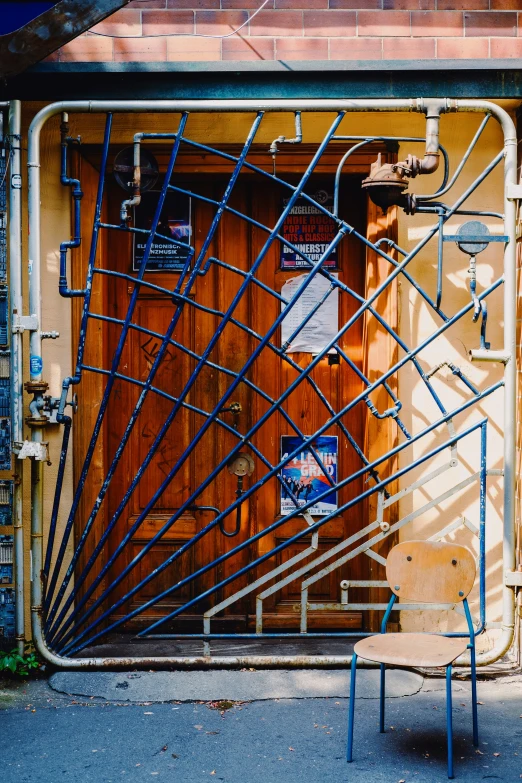 a group of metal pipes in front of a door