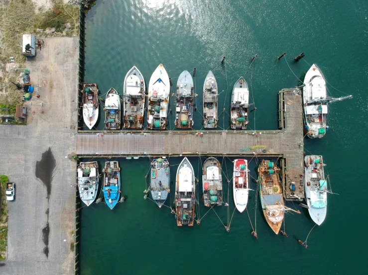 boats sitting in the water near a dock