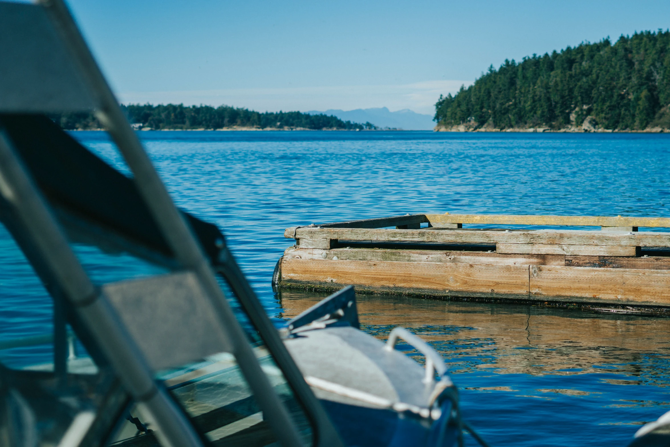 a boat dock sitting in the middle of a large lake