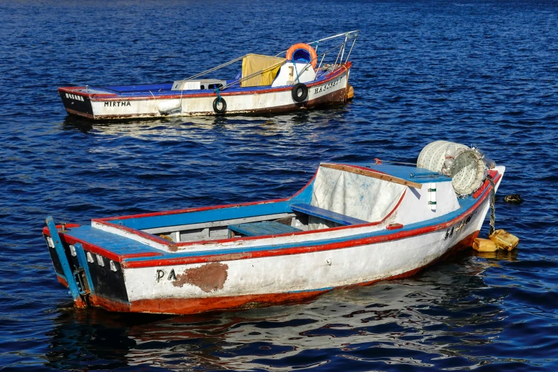 two boats are sitting in the middle of water