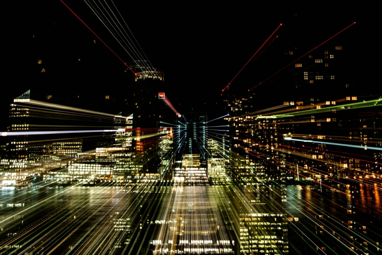 a city at night time with streaks of light from buildings