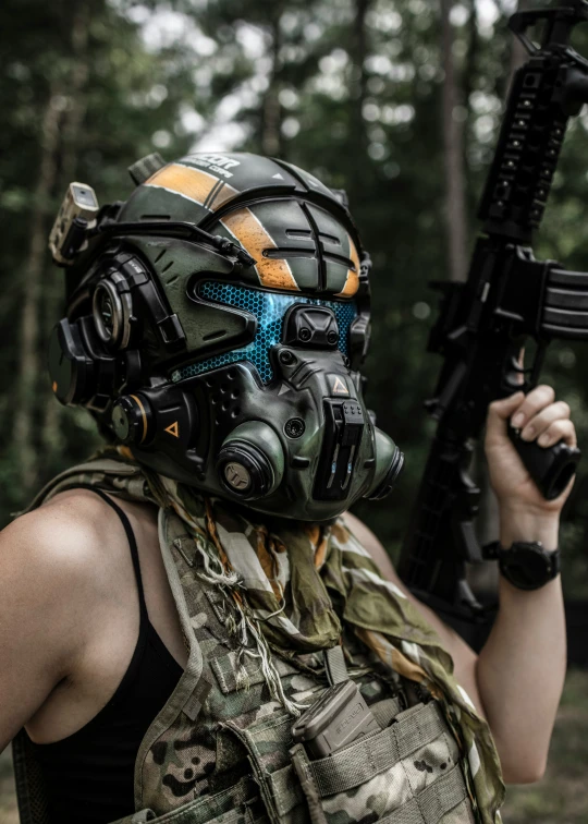 a woman in camouflage gear holding a machine gun