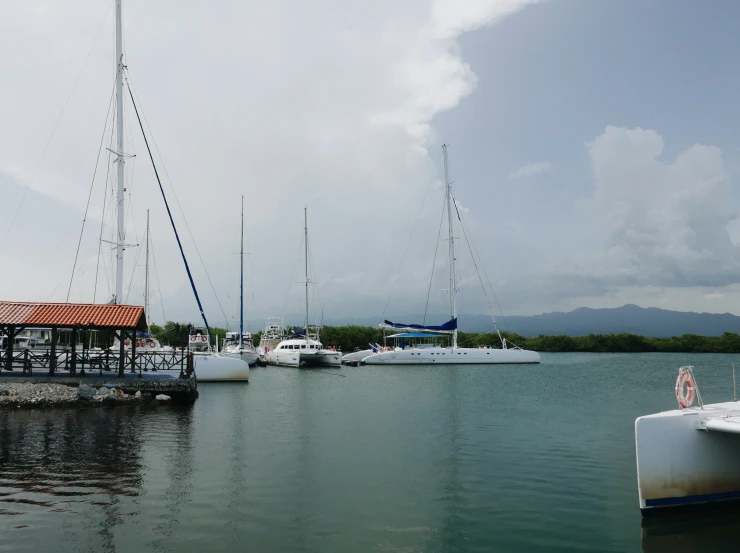 a harbor filled with lots of boats under cloudy skies