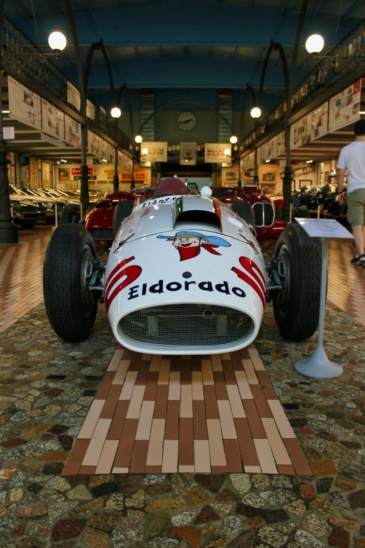 a race car on display in an antique car museum