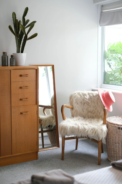 a living area with couch, chair and mirror