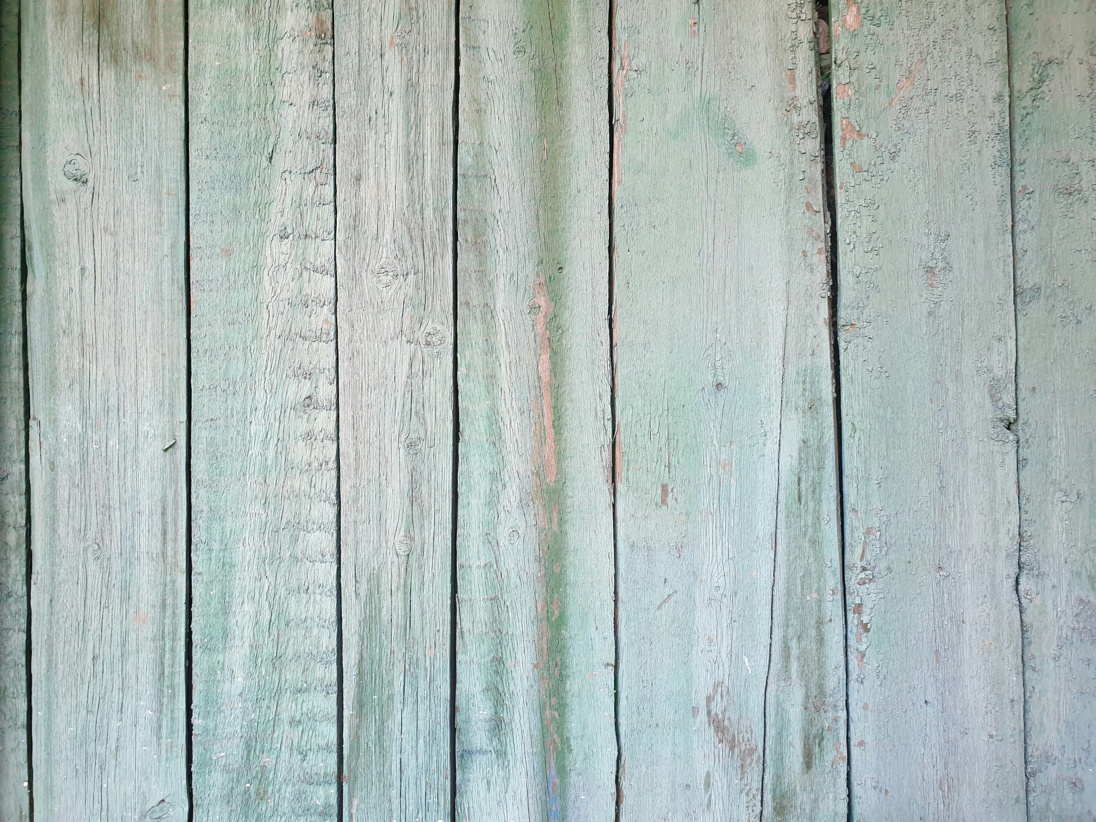 a wooden wall painted green and has no one on it