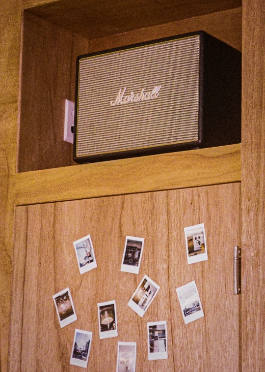 the wall of a cabinet with pictures of different people in it