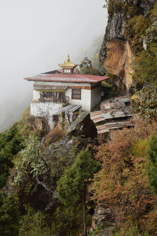 an old building is on the top of a mountain
