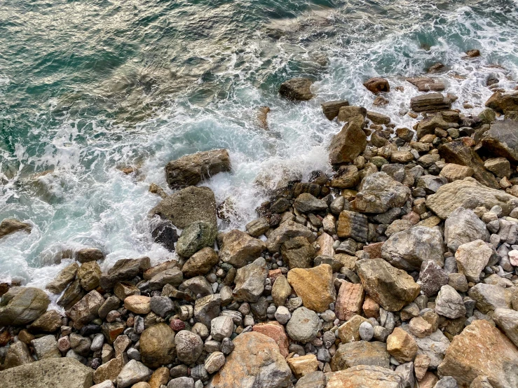 view from above of rough beach rocks next to the ocean