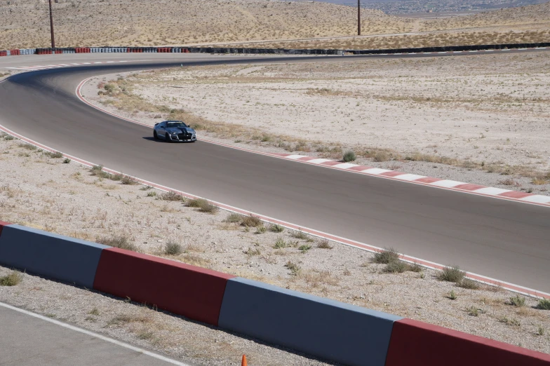 a car that is sitting on a curve in the road