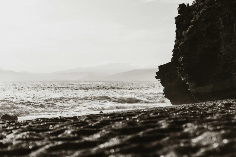 a lone beach next to an ocean with waves