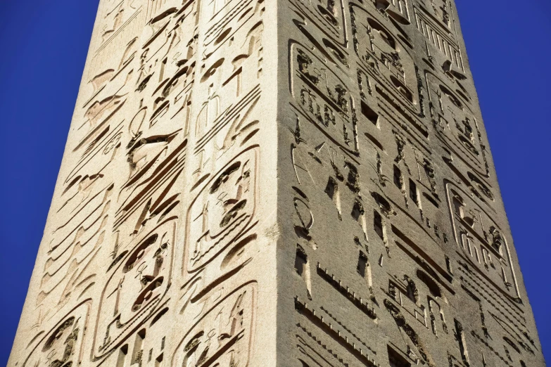 a tall stone building has many carvings on it