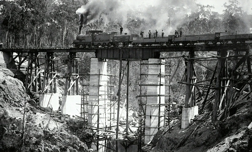 a train traveling on a bridge across a river
