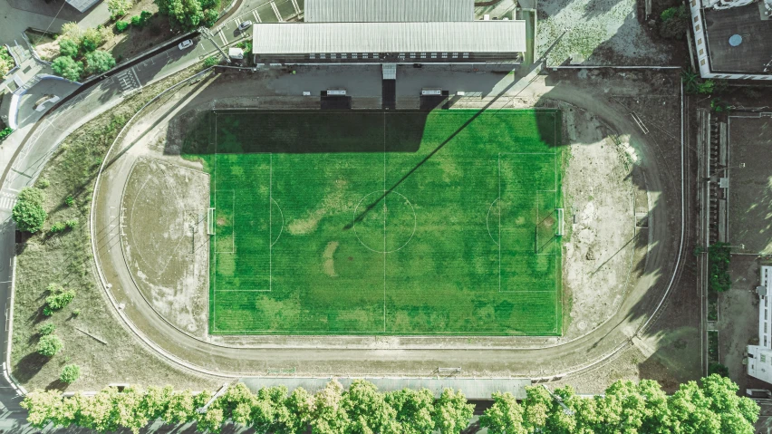 an aerial view of a soccer field and grass