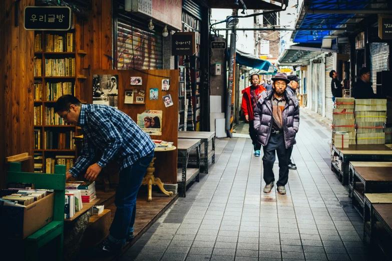 a man walking through an alley lined with people