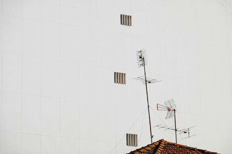 a weather vein on the wall of a building