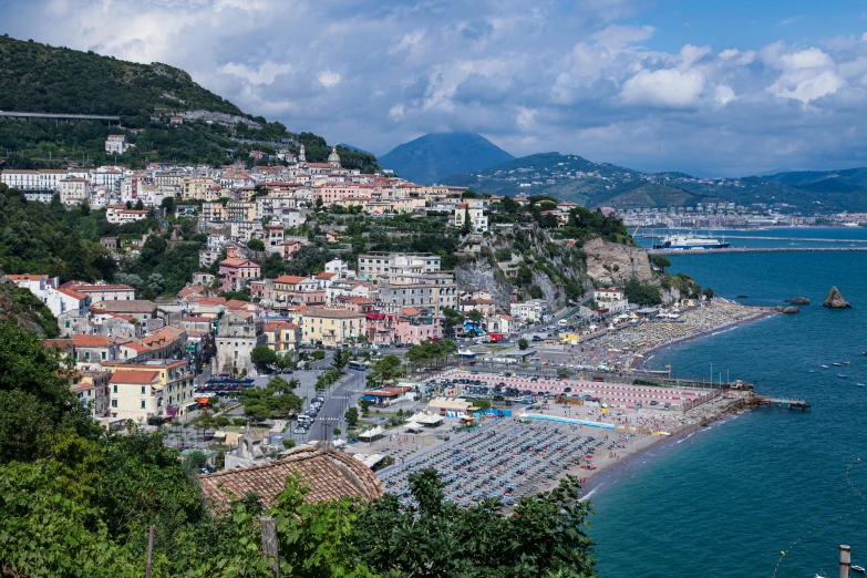 a city is on a cliff next to a body of water